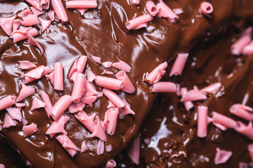 Curly pink sugar over chocolate cream on a dessert food detail