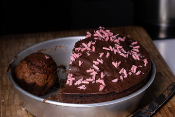 Chocolate cake with pink sugar candy slice on a plate close up still