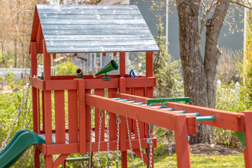 swingset with monkey bars, swings, tree house with accessories like megaphone, steering wheel, and...