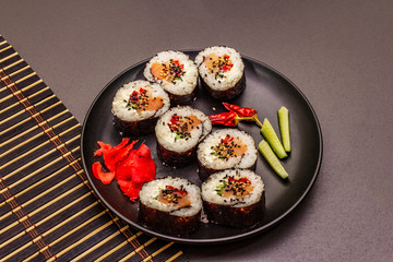 Korean roll Gimbap(kimbob). Steamed white rice (bap) and various other ingredients. Trendy black background