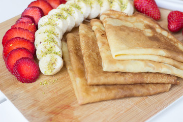 Pancakes filled with fresh strawberries and banana - 347627235