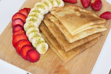 Pancakes filled with fresh strawberries and banana - 347627693