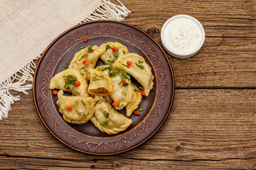 Dumplings stuffed stewed cabbage and sour cream. Traditional Ukrainian dish varenyky