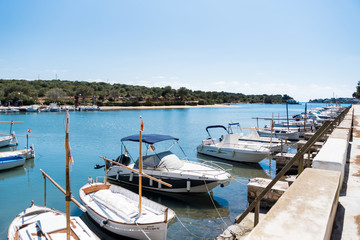 Fototapeta na wymiar View of port and boats with blue sky, Portocolom, Mallorca