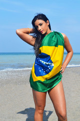 .Pretty woman standing on beach in a Brazilian flak