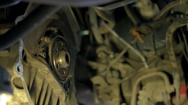 Close up mechanic uninstalling car clutch. Repairman taking of unscrewed car clunch