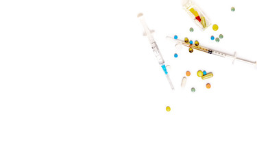 Syringes and pills on a white background. On white background. Copy space for text