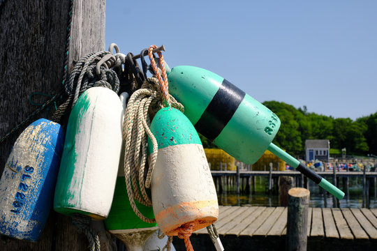 Colorful lobster floats decorate a wooden lobstrermans dock on the Maine Coast