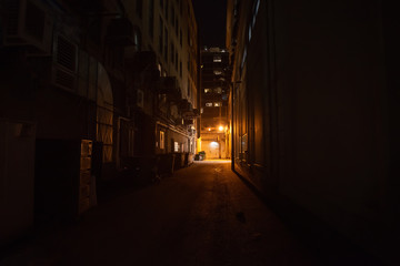 Dark and eerie urban city alley at night