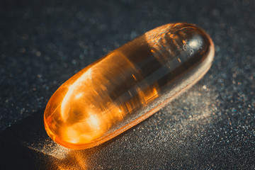 Omega 3 and vitamin D pills. Yellow capsules with fish oil. Biologically active additives with cod liver oil for protect against SARS-CoV2 (COVID-19) infection.