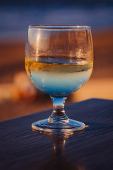 Glass of wine on a table at a beach resort