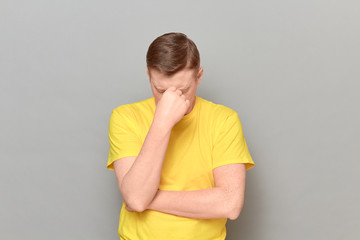 Portrait of thoughtful tired mature man touching bridge of his nose