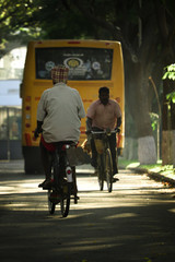 Naklejka premium An old village man going for work on a bicycle in the morning