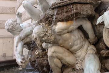 Plastic pose and dramatic expression in this fountain at the entrance of Palace Hoffburg, Wien