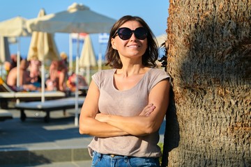 Portrait of beautiful smiling mature woman relaxing in resort hotel