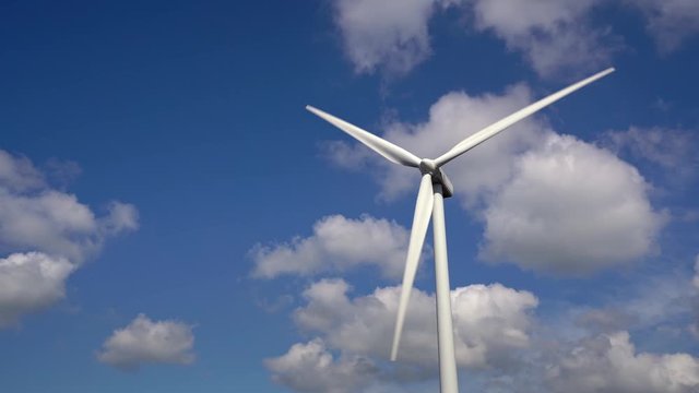 Hi resolution footage of wind turbine spinning against a blue sky with white fluffy white clouds, Ovenden Mooor, Halifax, west yorkshire, uk