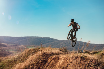 Fototapeta na wymiar Dirt bike rider jumping in bike park on mountain bike