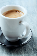 Obraz na płótnie Canvas Cup of coffee on bright wooden background.