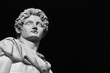 Ancient marble statue of mythical character Castor or Pollux, dated back to the 1st century BC, located at the top of monumental balustrade in Capitoline Hill in Rome (Black and White with copy space)