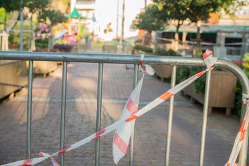 Fototapeta na wymiar Barrier tape - quarantine, isolation, entry ban. Do not cross on the park