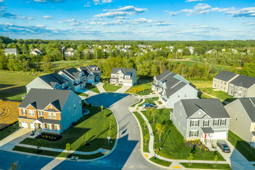 Classic cul de sac dead end circle street surrounded by mansion style luxury homes in a new residential real estate development neighborhood in Maryland, East Coast United States, aerial view