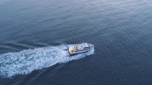 AERIAL DRON ORBIT FOLLOWING FISHING BOAT, MEDITERRANEAN BLUE SEA