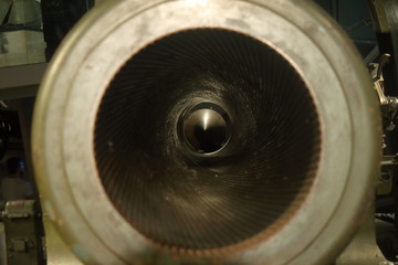 detail of the mouth of a large caliber ww2 cannon, the internal lining and the bullet at the bottom...