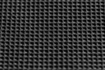 Naklejka premium Black symmetrical synthetic fiber texture. Wattled black fabric texture. Close up. 