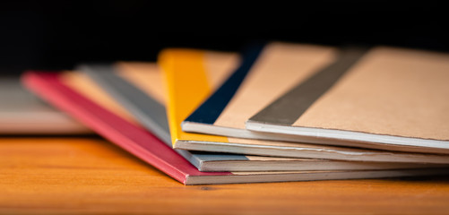 Close Up of Several Notebooks with Unfocused Background.