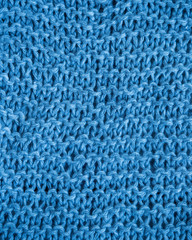 Blue knitting texture on knitting needles with cotton