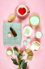 Obraz na płótnie Canvas Self-care wellbeing home spa creative concept flatlay with herbal hibiscus tea, pro environmental plastic free beauty products and moisturisers on feminine pink background. Vertical orientation.