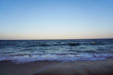 Australian beach sunset, blue sky and sand