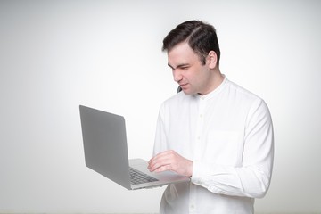unhappy young man holding laptop