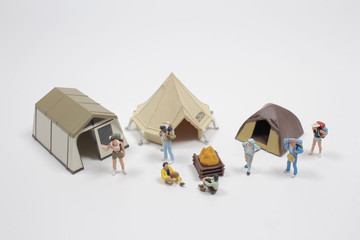 mini people : travelers or backpackers walking on board