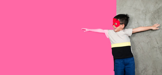 Gender selection, children's fantasies, boys dressed in superhero costumes are reaching out to pink backgrounds, identifying gender or development of young children.