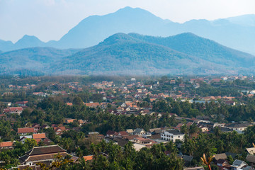 Fototapeta na wymiar View of Luang Prabang town from the top of Mt.Phu Si (or Mt.Phou Si) high hill in the centre of the old town of Luang Prabang in Laos. Luang Prabang is popular UNESCO world heritage sites in Laos.