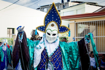 closeup human in original vivid costume poses for photo at dominican carnival