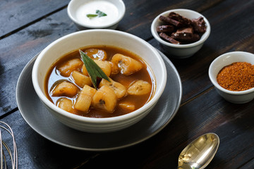 Banana Compote served with pandan leaf on the ceramic bowl.