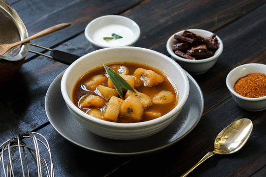Banana Compote served with pandan leaf on the ceramic bowl.