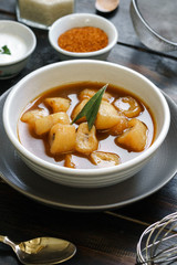 Banana Compote served with pandan leaf on the ceramic bowl.