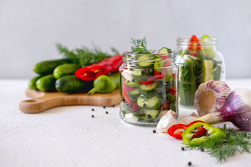 Homemade fermented vegetables in jars. Fermentation of cucumber with pepper.