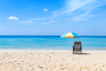 Beach chair under colorful umbrella on beautiful beach look to blue sea and clear blue sky, summer outdoor day light, take a break to relax on the beach, holiday and vacation destination to South of T