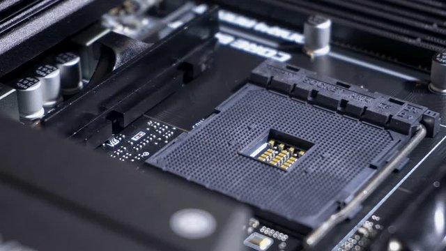 Central processing unit (CPU) pin grid array socket inside computer, slow pan right, close up
