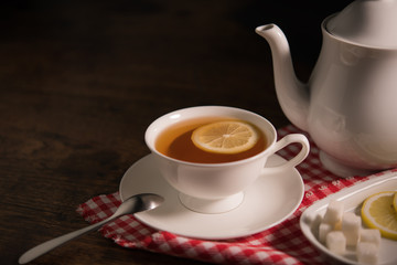 Cup of tea with lemon on wooden table