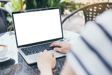 computer mockup image blank screen with white background for advertising,hand woman work using laptop contact business search information on desk at coffee shop.marketing and creative design