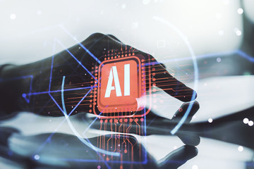 Double exposure of creative artificial Intelligence abbreviation and hand working with a digital tablet on background. Future technology and AI concept