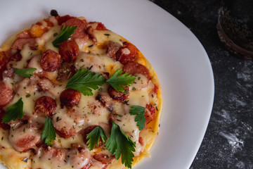 homemade pizza without oven. sausage, cheese, ham. meat, ripe, tomato. pizza making. small pizzeria
