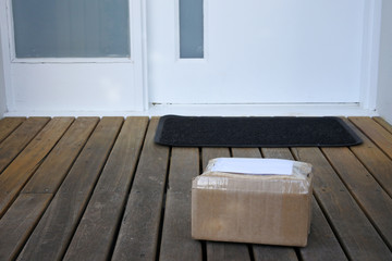 Package postal box courier delivery on home doorstep