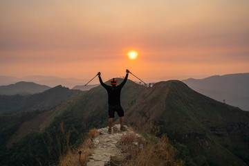 traveler man hiking enjoying in the mountains with backpack at Khao Chang Puak mountain Thailand