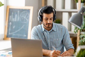 man working on a laptop at home.